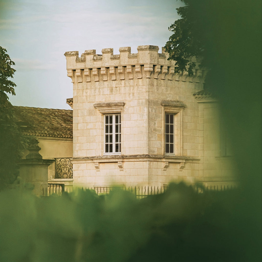 Close up image of one of Château Canon's turrets seen from the vineyards.