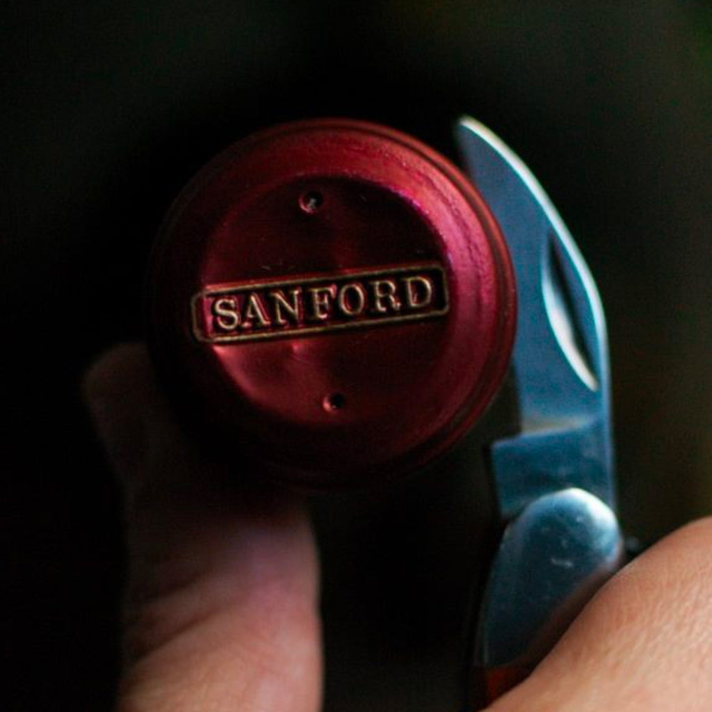 Waiter's Friend Corkscrew cutting into a Sanford Wine Bottle Capsule 