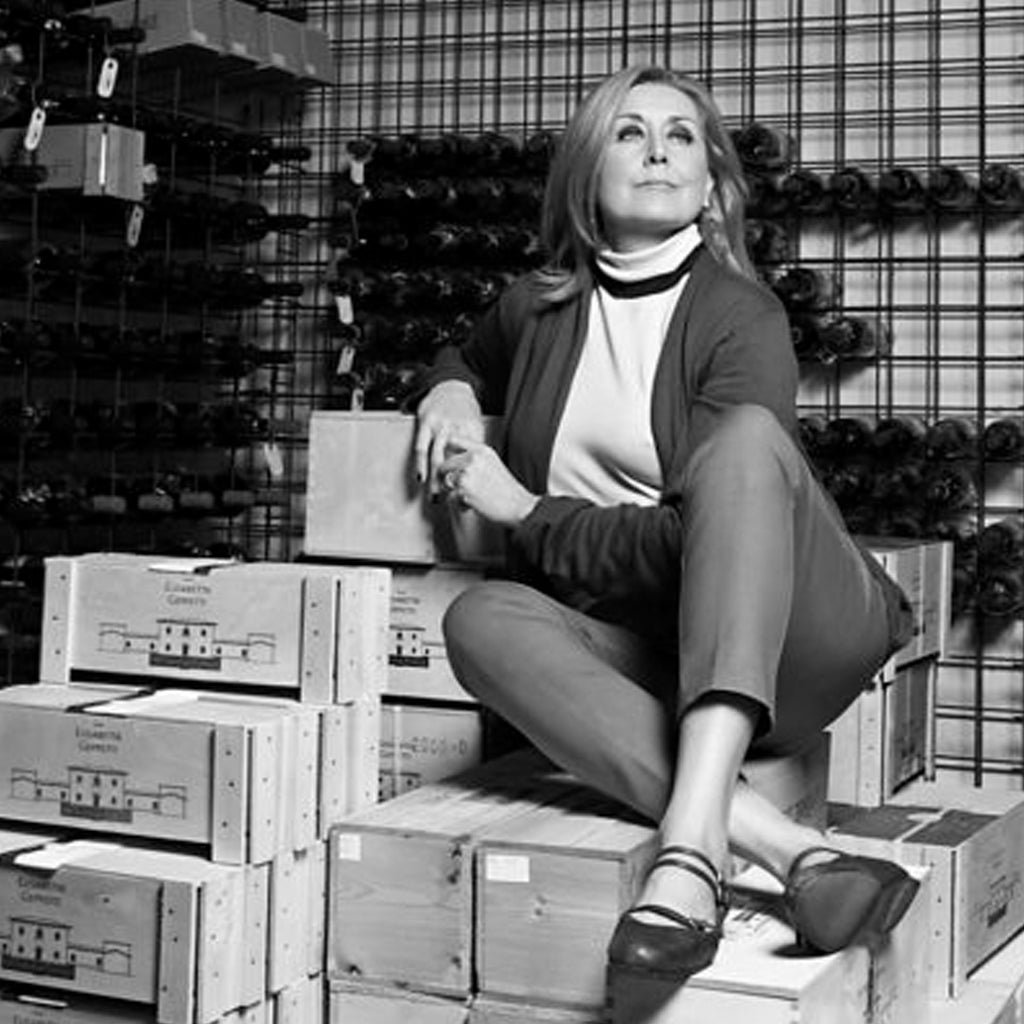 Elisabetta Geppetti sat atop wooden wine crates of Fattoria Le Pupille Wines