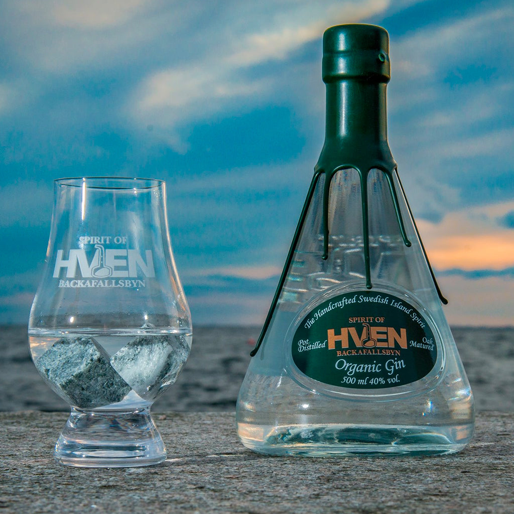 Bottle of Spirit of Hven Organic Gin & Glass on the beach.