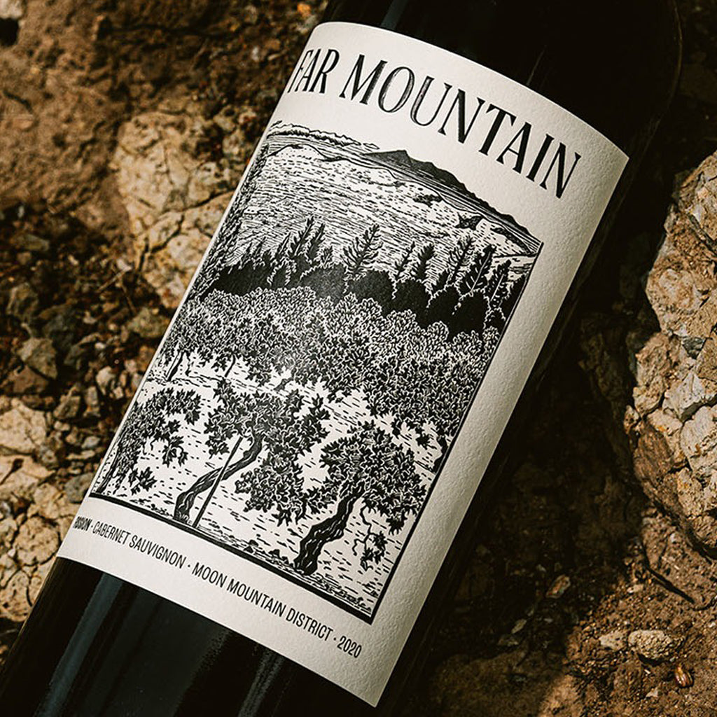 Far Mountain Cabernet Sauvignon Bottle from the Moon Mountain District AVA laying in the vineyard soils