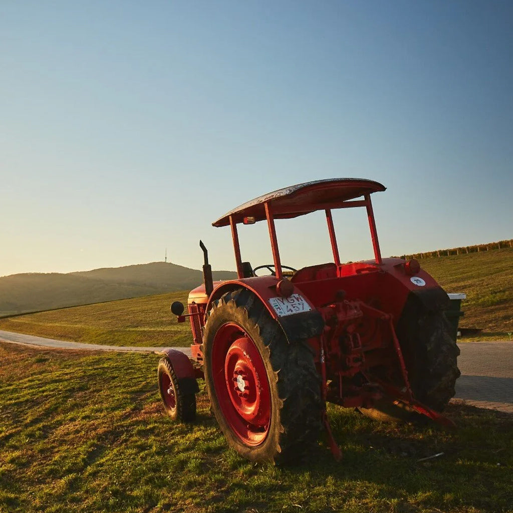 A tractor working the steep vineyard slopes at Chateau Dereszla, highlighting the authentic viticulture of this historic Hungarian wine estate.